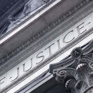close up of word justice on building